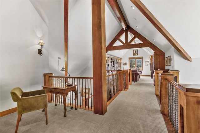 hall with vaulted ceiling with beams and light carpet