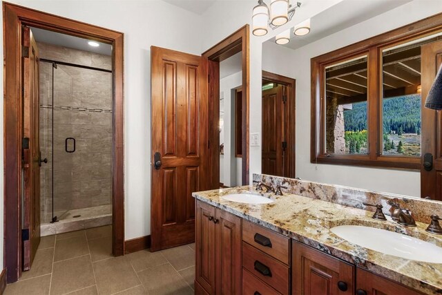 bathroom featuring vanity, tile patterned floors, and a shower with shower door