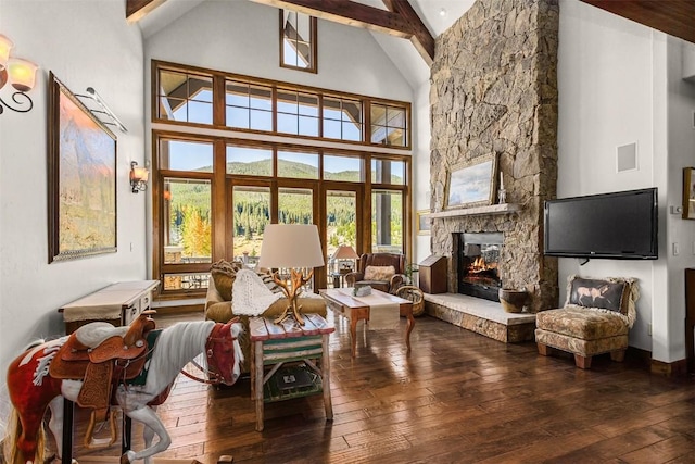 living room with a fireplace, beam ceiling, high vaulted ceiling, and hardwood / wood-style floors