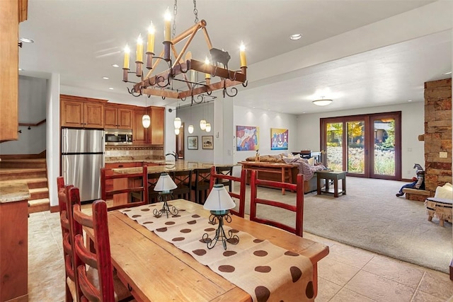 dining room featuring light colored carpet and a notable chandelier