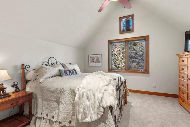 bedroom featuring ceiling fan, lofted ceiling, and light carpet