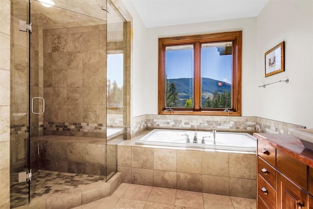 bathroom featuring tile patterned flooring, a mountain view, vanity, and plus walk in shower