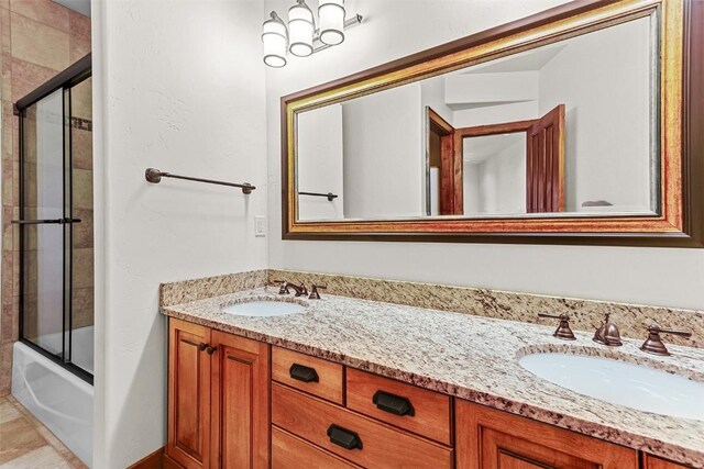 bathroom with vanity and bath / shower combo with glass door