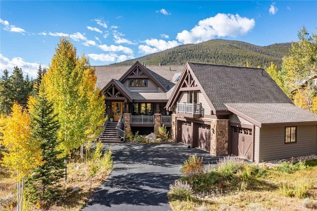 view of front of home featuring a mountain view, a porch, and a garage