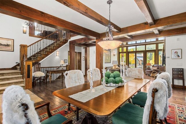 dining room with beam ceiling, dark hardwood / wood-style flooring, and french doors