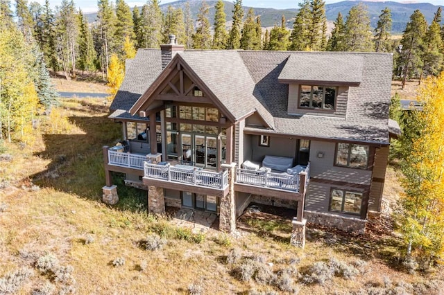 back of property with a mountain view