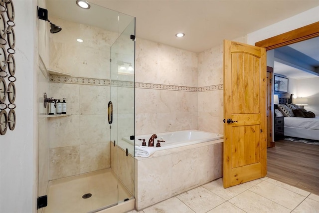 bathroom featuring tile walls, tile patterned floors, and independent shower and bath