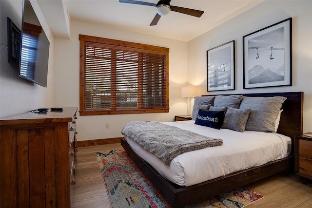 bedroom with ceiling fan and light hardwood / wood-style flooring