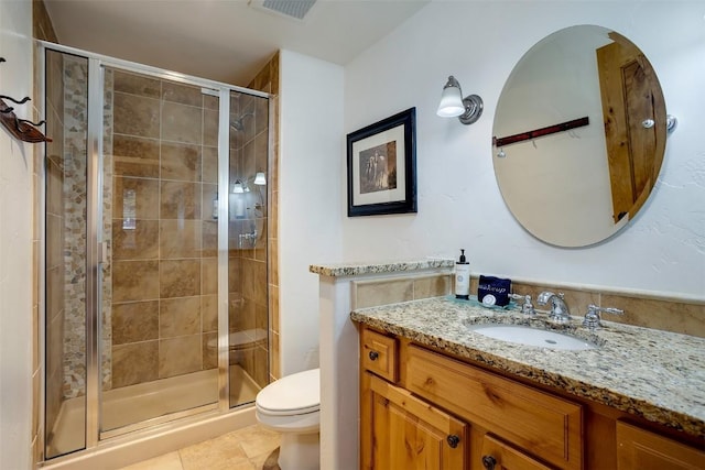 bathroom featuring vanity, an enclosed shower, tile patterned flooring, and toilet