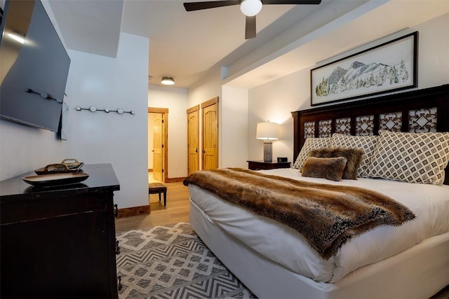 bedroom featuring wood-type flooring, a closet, and ceiling fan