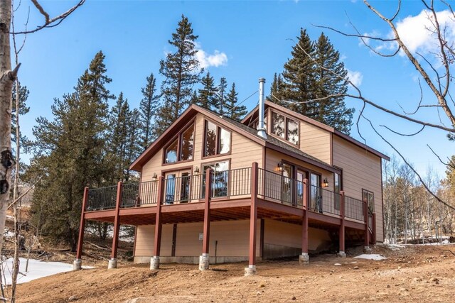 rear view of house with a wooden deck