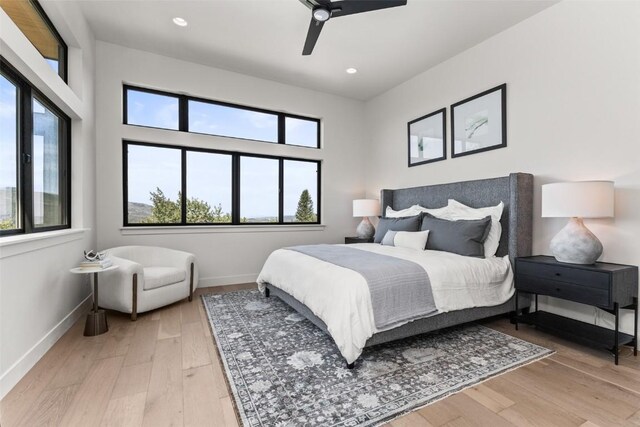 bedroom featuring ceiling fan and light hardwood / wood-style flooring