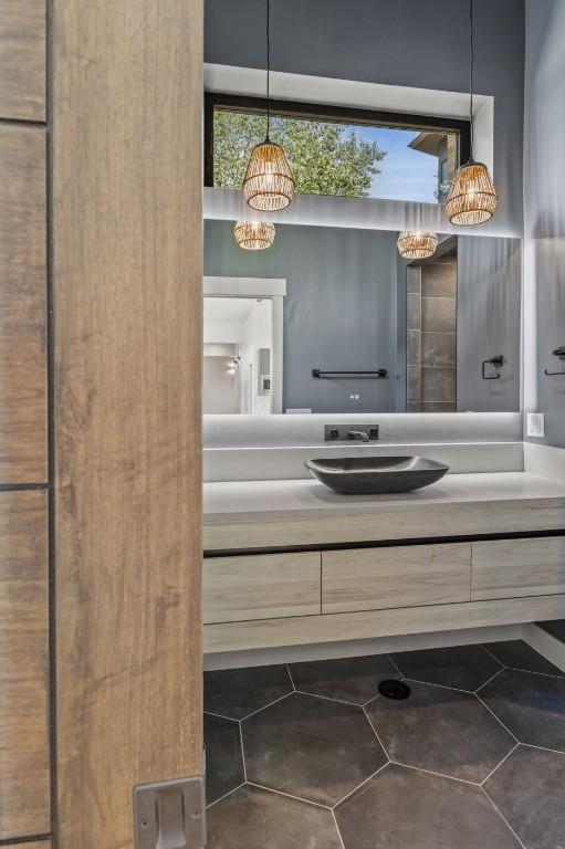 bathroom with vanity and a notable chandelier