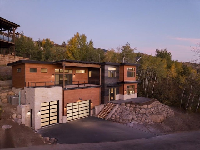 view of front facade featuring a balcony and a garage