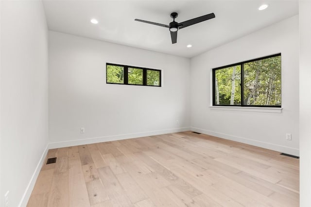 spare room with ceiling fan and light wood-type flooring