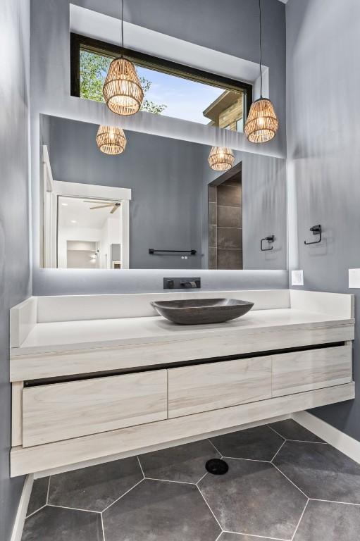 bathroom featuring vanity and a notable chandelier