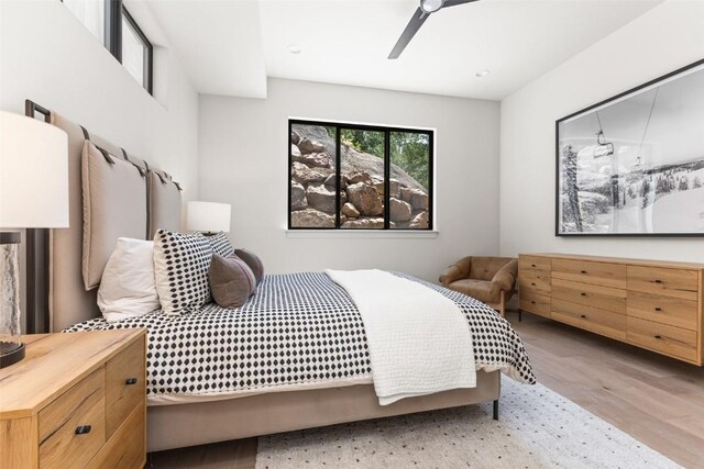 bedroom with light wood-type flooring and ceiling fan