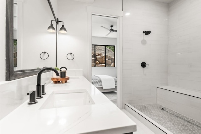 bathroom with walk in shower, vanity, and ceiling fan