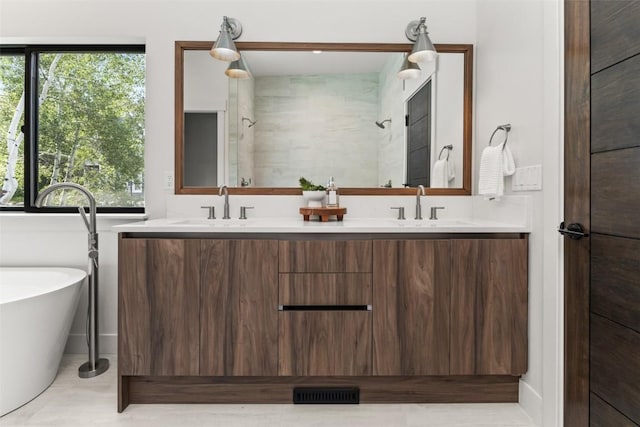 bathroom with tile patterned flooring, vanity, and separate shower and tub