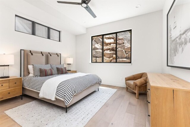 bedroom with ceiling fan and light hardwood / wood-style flooring