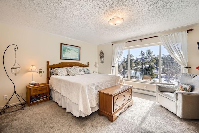 bedroom with a baseboard radiator, carpet, and a textured ceiling