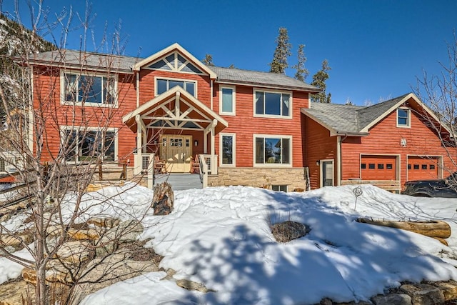 view of front of property featuring stone siding and an attached garage