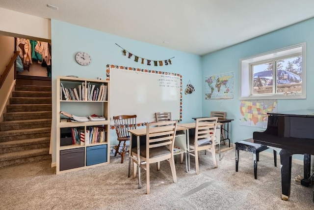 carpeted dining space featuring stairs