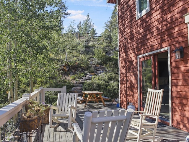 wooden terrace with outdoor dining area