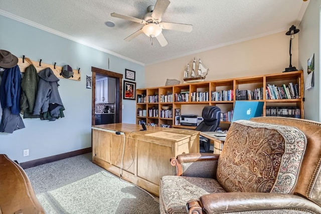 carpeted office space featuring baseboards, a textured ceiling, a ceiling fan, and crown molding