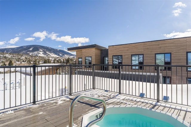 snow covered pool featuring a mountain view