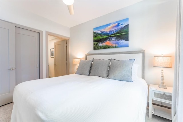 carpeted bedroom featuring a closet and ceiling fan