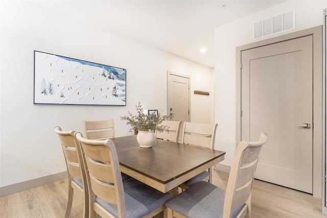 dining space with light wood-type flooring