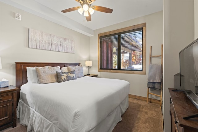 carpeted bedroom with ceiling fan and baseboards