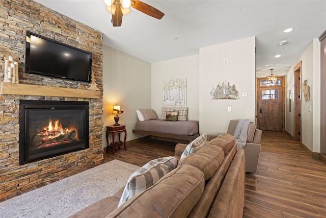 bedroom with recessed lighting, baseboards, wood finished floors, and a stone fireplace