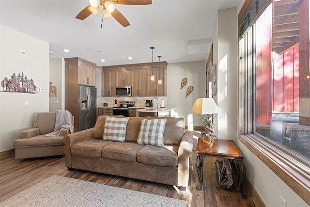 living room with baseboards, ceiling fan, wood finished floors, and recessed lighting