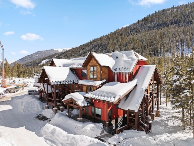 exterior space featuring a mountain view and a view of trees