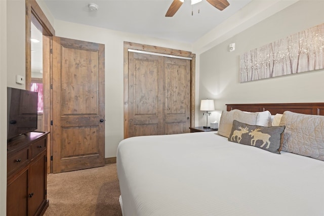 carpeted bedroom featuring a ceiling fan and a closet