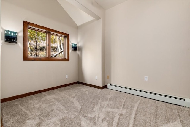 spare room featuring lofted ceiling, light carpet, and a baseboard radiator