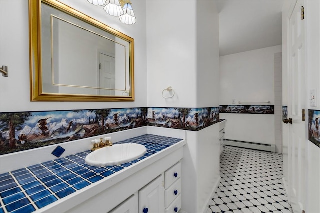 bathroom with tile patterned flooring, vanity, and baseboard heating