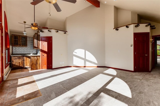 unfurnished living room with carpet flooring, high vaulted ceiling, ceiling fan, and beamed ceiling