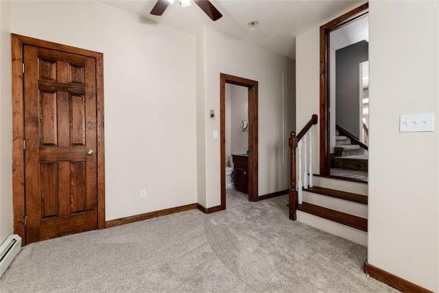 interior space featuring ceiling fan and a baseboard heating unit