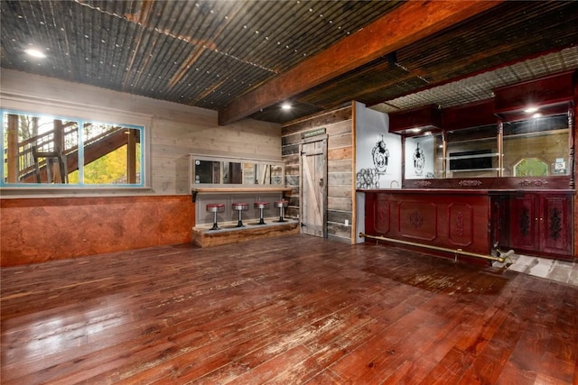 bar featuring beam ceiling and wood-type flooring