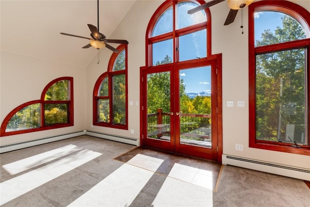 unfurnished sunroom with ceiling fan, vaulted ceiling, and a baseboard heating unit