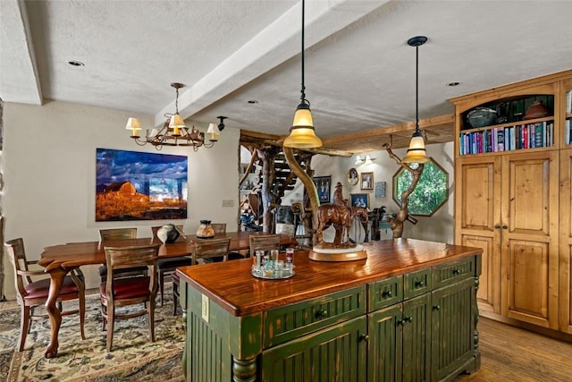 bar with beam ceiling, butcher block countertops, pendant lighting, a chandelier, and light hardwood / wood-style floors