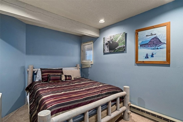 bedroom featuring carpet flooring, a textured ceiling, and a baseboard heating unit