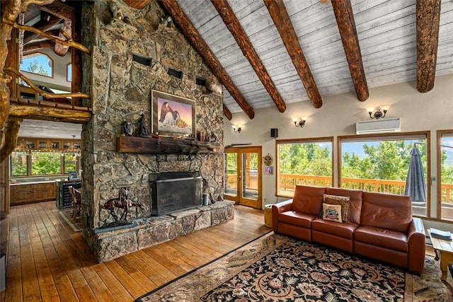 living room with a wall mounted air conditioner, wood-type flooring, high vaulted ceiling, beamed ceiling, and a fireplace