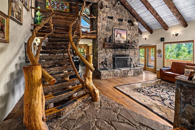 living room with high vaulted ceiling, hardwood / wood-style flooring, a fireplace, beamed ceiling, and wood ceiling