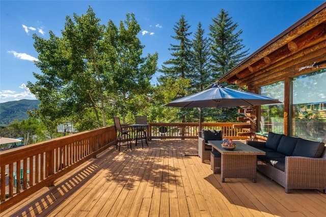 wooden deck featuring outdoor lounge area and a mountain view