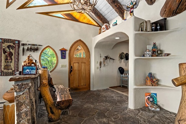 entrance foyer featuring vaulted ceiling with beams and wood ceiling