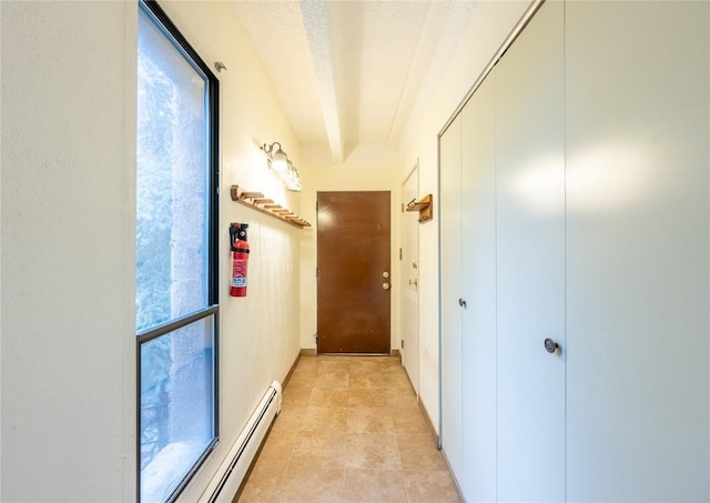 hallway with a baseboard radiator and a textured ceiling